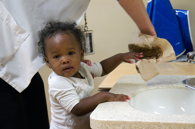 older infant washing hands