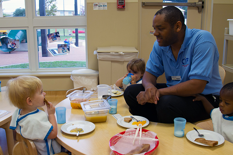 caregiver and infants eating