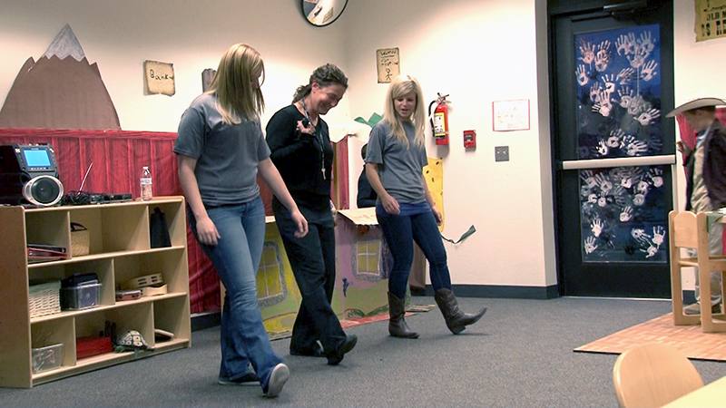 three staff members line-dance 